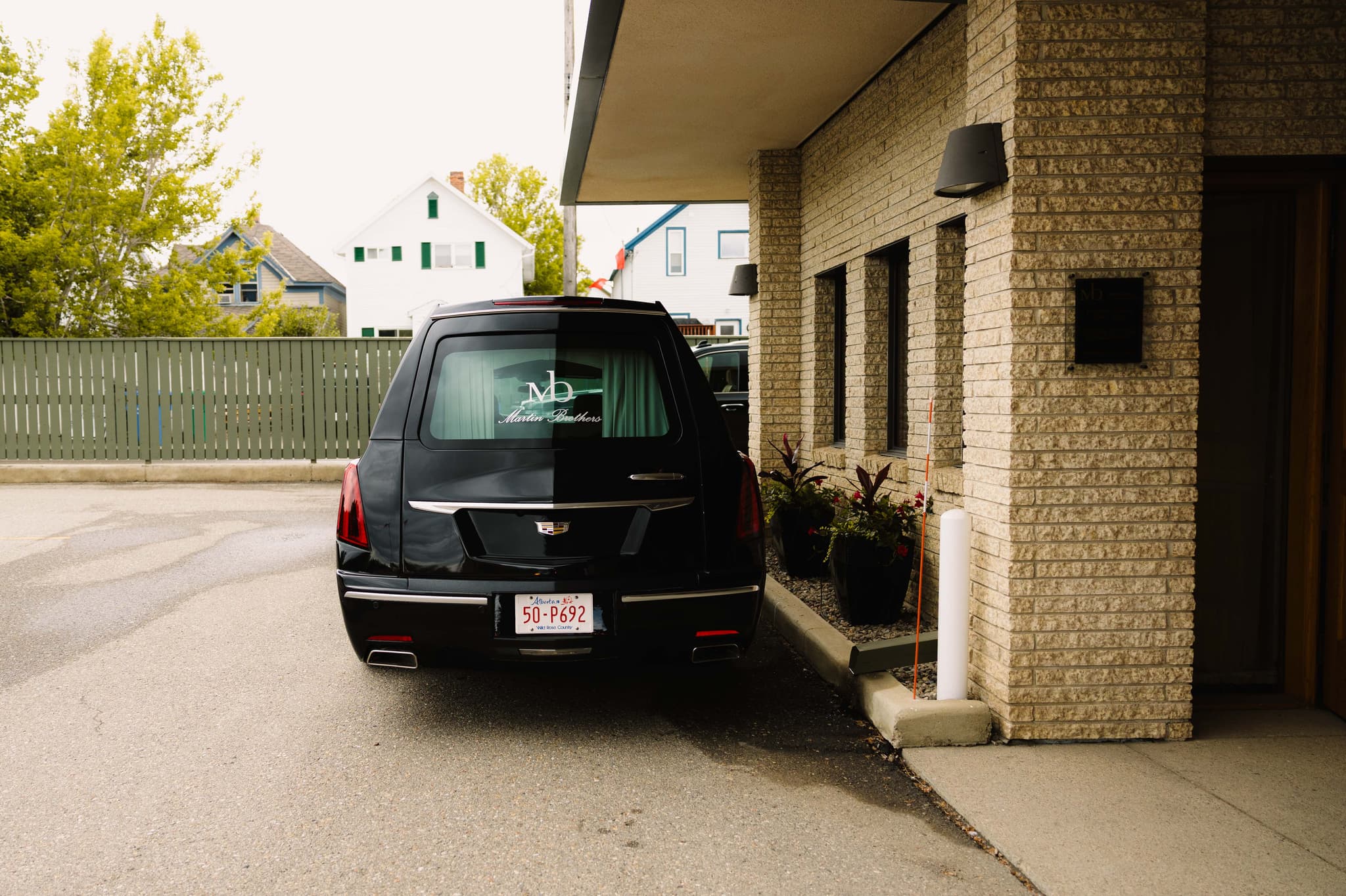 A Martin Brothers hearse at the funeral home entrance in Lethbridge